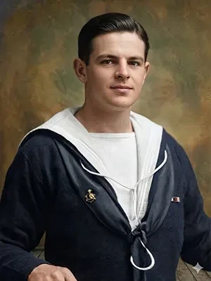 Colorised portrait photograph of Herbert John Budgen wearing a dark Royal Navy sailor uniform with a white lanyard.